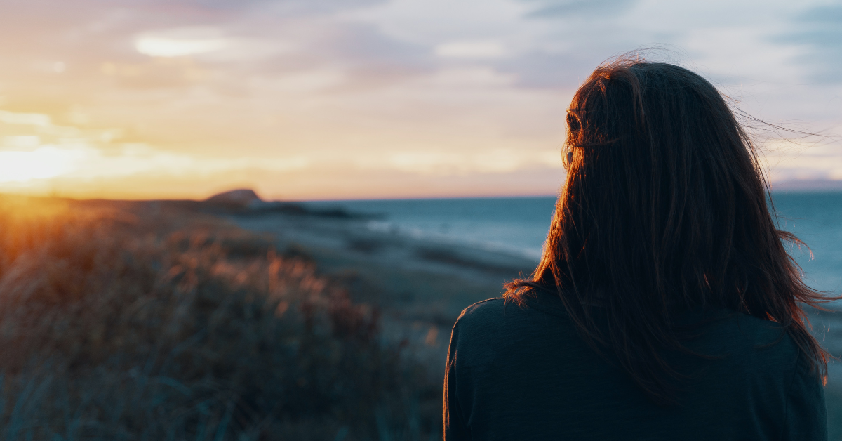 Person staring out at the sea.
