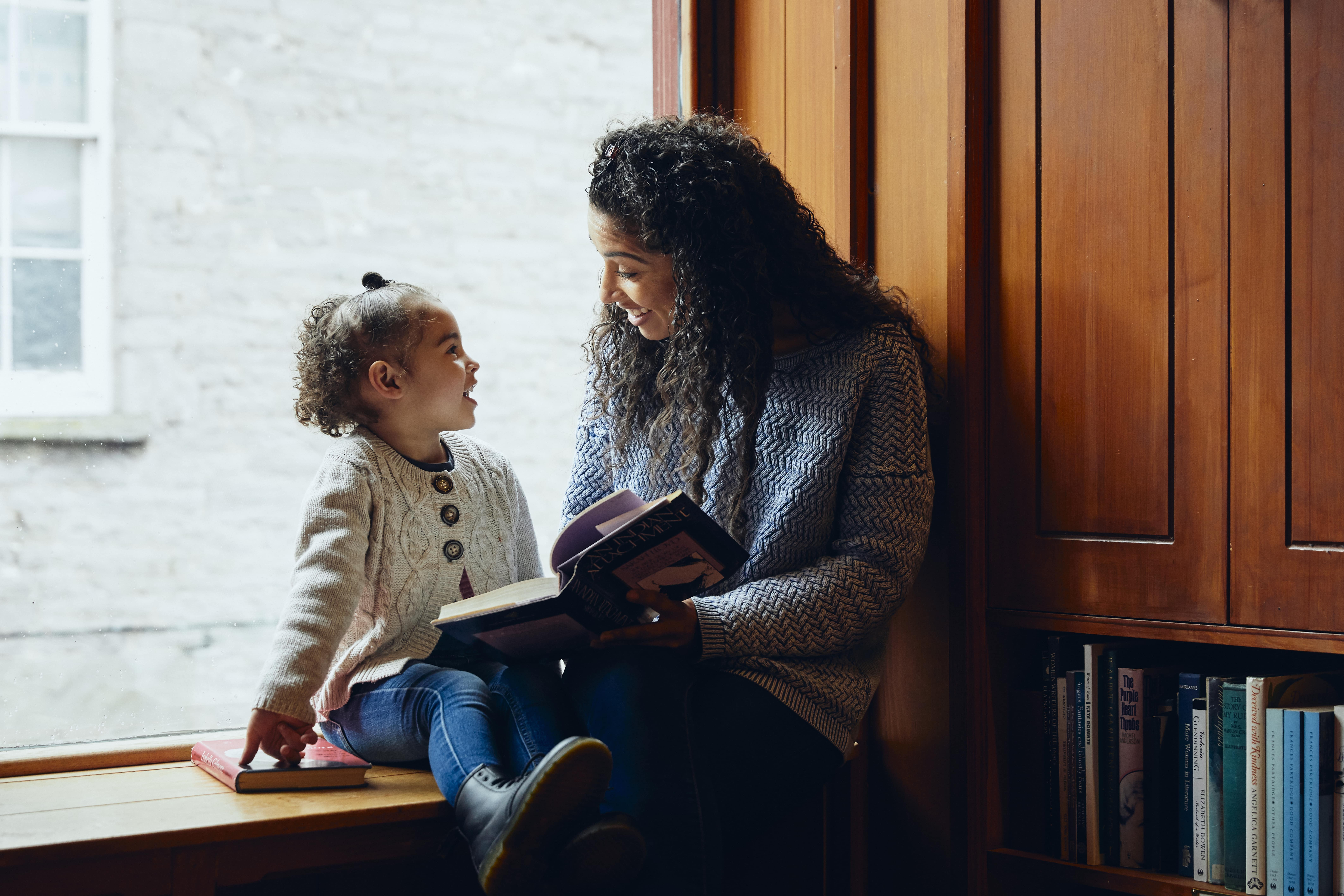 A person reading to a child.