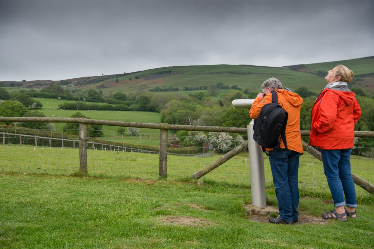 Two people standing in a field.